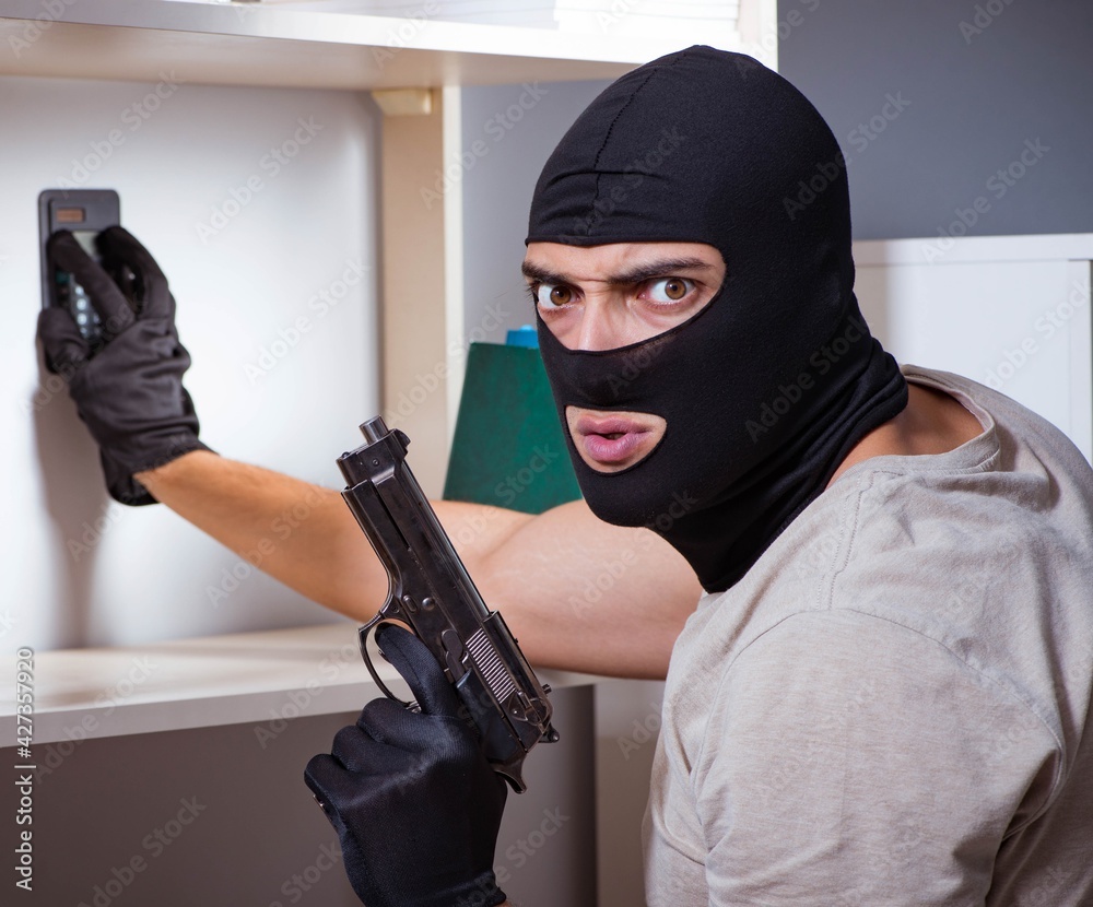 Burglar wearing balaclava mask at crime scene Burglar wearing balaclava mask at crime scene