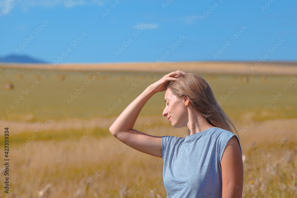 Harvest: ripe wheat grows in the field. Golden grain and hand close-up Harvest: ripe wheat grows in the field. Golden grain and hand close-up