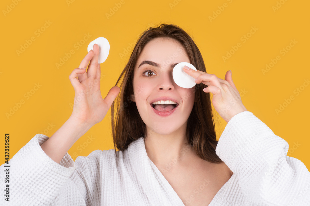 Beautiful young woman with clean fresh skin. Woman taking off makeup with cotton wipe sponge. Daily healthy beauty routine. Beautiful young woman with clean fresh skin. Woman taking off makeup with cotton wipe sponge. Daily healthy beauty routine.