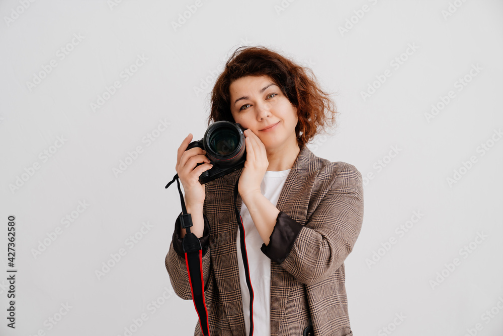 brunette woman in T-shirt and checkered jacket on a white background with camera brunette woman in T-shirt and checkered jacket on a white background with camera
