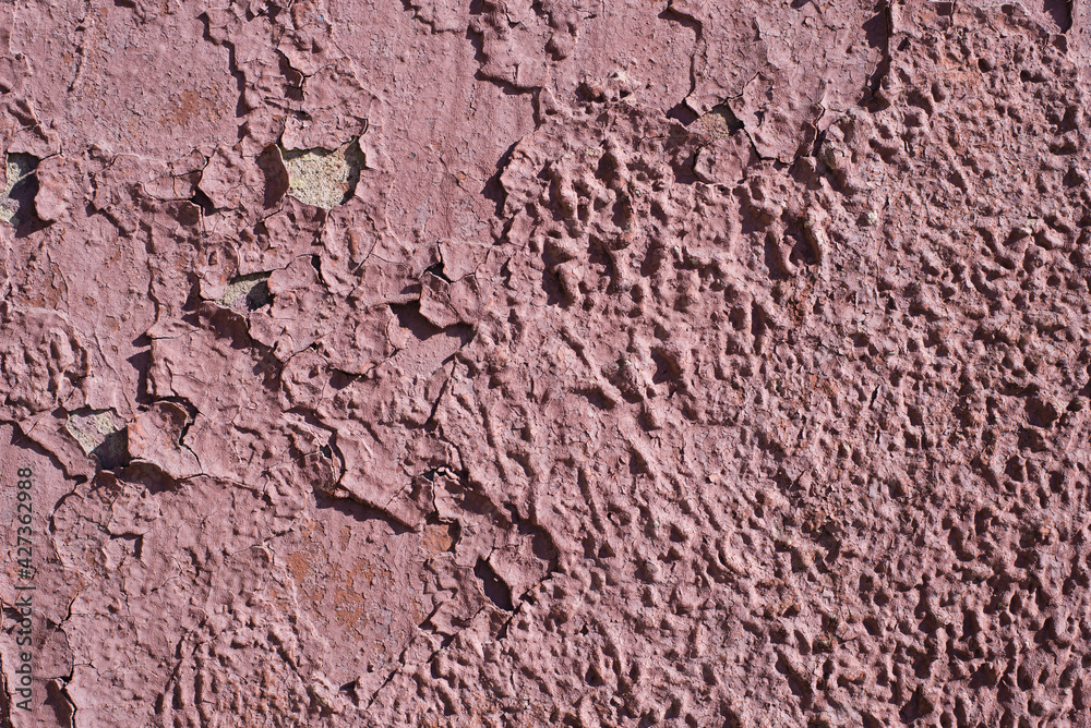 Old, cracked burgundy paint on the wall. Textured surface, background Old, cracked burgundy paint on the wall. Textured surface, background