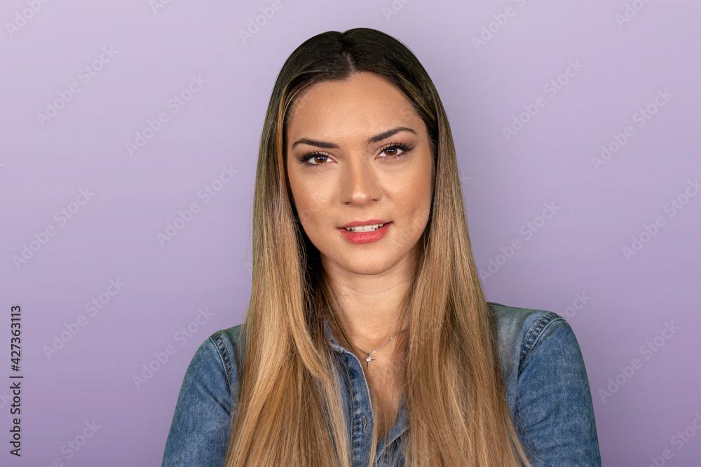 Portrait of confident beautiful woman with long hair, wearing casual clothes, smiling with white teeth at the camera, studio background Portrait of confident beautiful woman with long hair, wearing casual clothes, smiling with white teeth at the camera, studio background