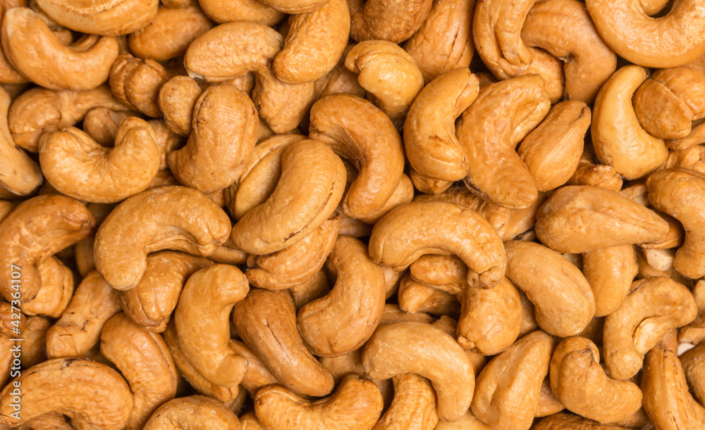 Top view roasted cashew nuts for background, close-up shot. Top view roasted cashew nuts for background, close-up shot.
