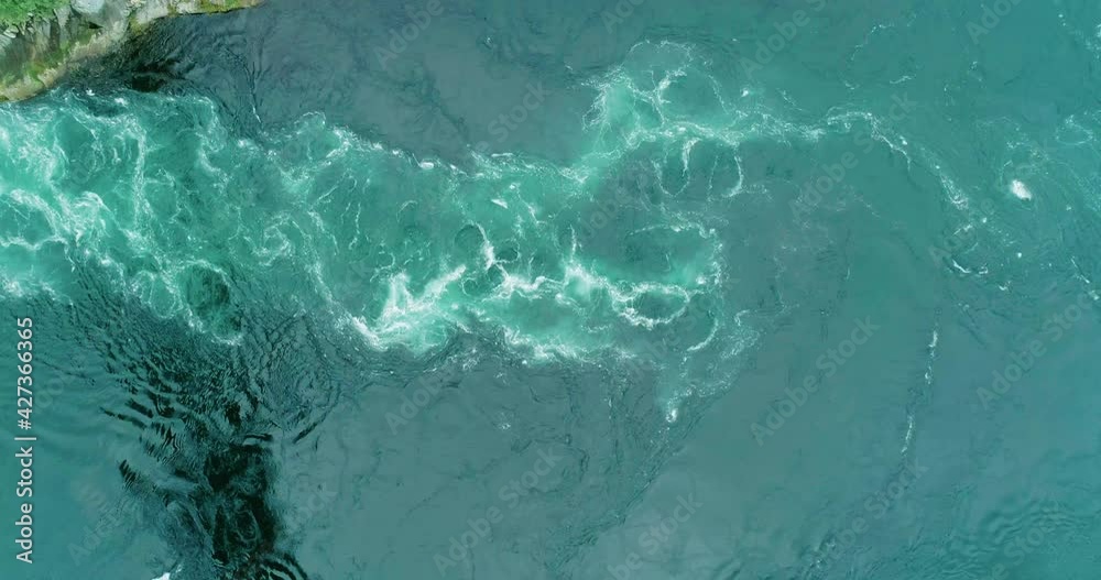 Aerial top down view of blue turquoise whirlpools in Saltstraumen maelstrom Aerial top down view of blue turquoise whirlpools in Saltstraumen maelstrom