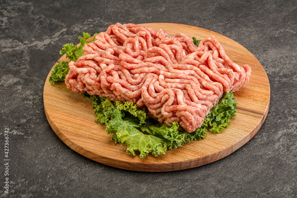 Raw pork minced meat over board