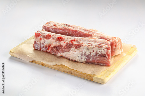 Raw pork ribs over board