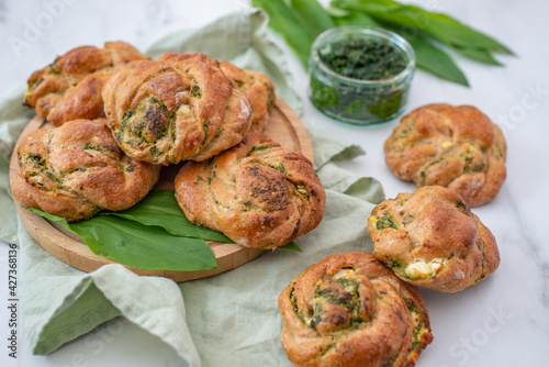 home made whole grain bread rolls with wild garlic on a table