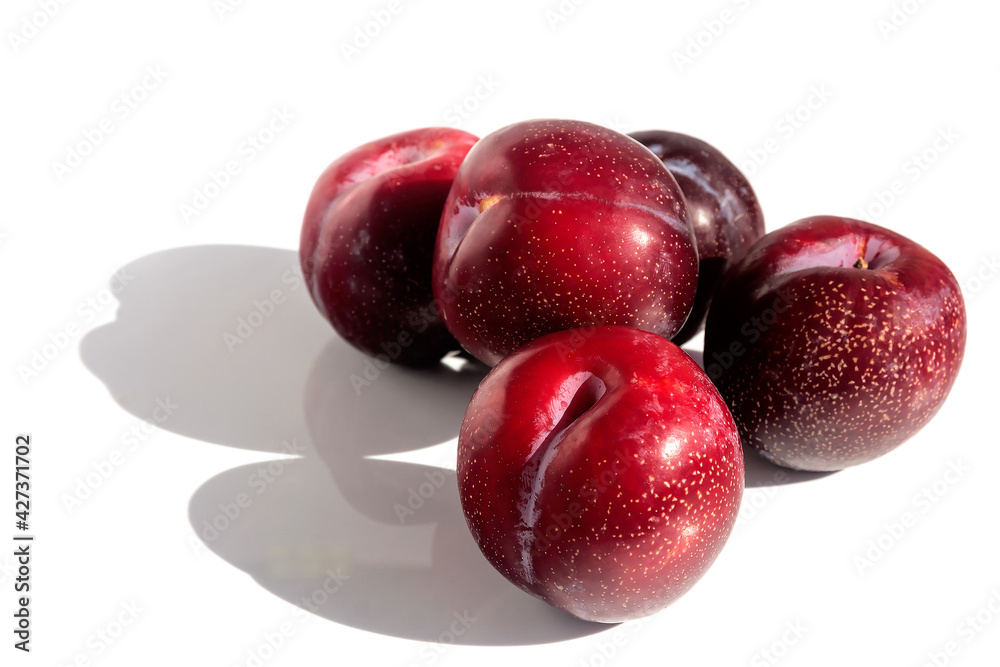 Fresh juicy tasty plums on an isolated white background. 