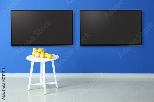 Modern TV sets hanging on w...