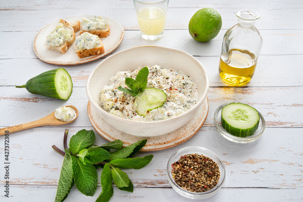 Preparation of Mediterranean tzatziki with yoghurt, cucumber, mint and other ingredients Preparation of Mediterranean tzatziki with yoghurt, cucumber, mint and other ingredients