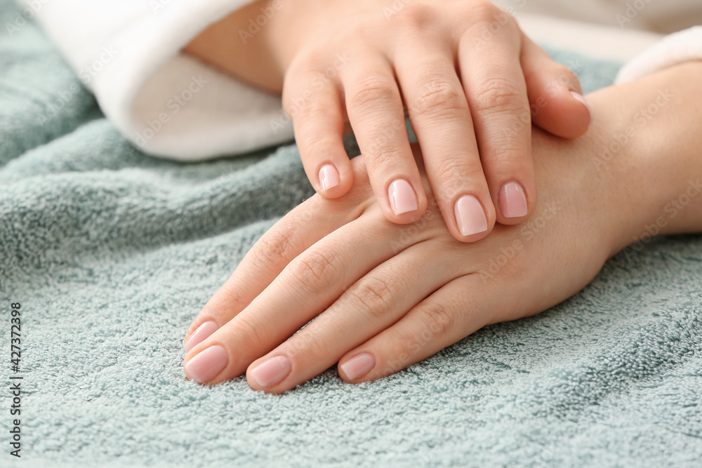 Beautiful female hands on towel, closeup