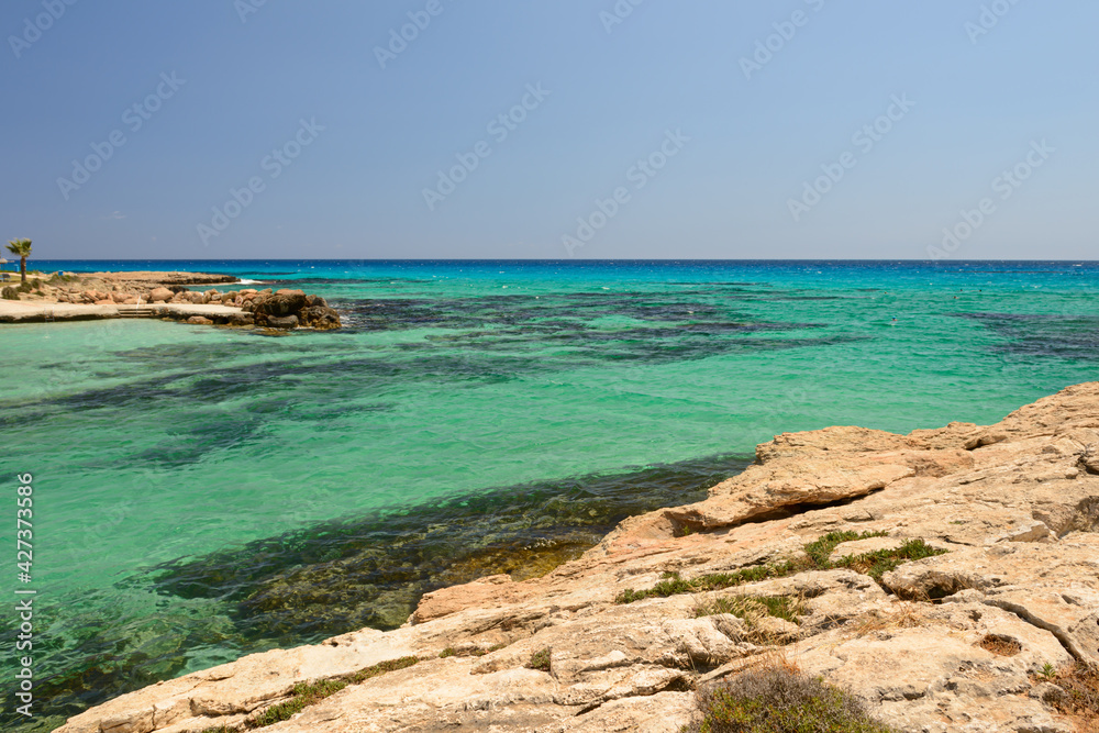 Rocky seashore in a Mediterranean resort with turquoise sea