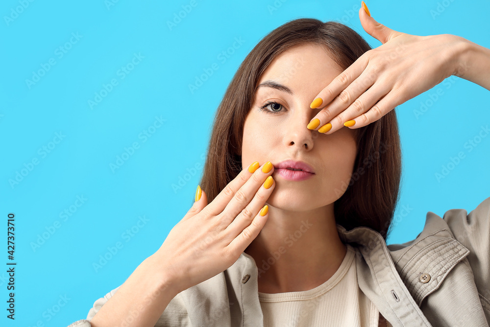 Young woman with beautiful manicure on color background Young woman with beautiful manicure on color background