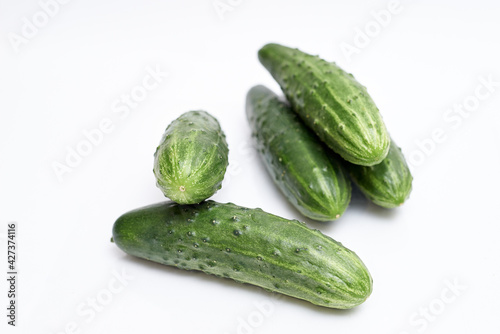 fresh green cucumbers on white background