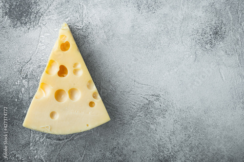 Maasdam cheese, on gray stone background, top view flat lay, with copy space for text