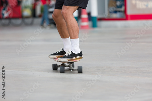 Young people playing skateboarding outdoor. Sports Concept