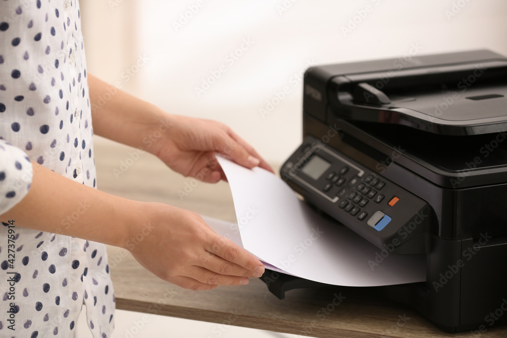Employee using modern printer in office, closeup Employee using modern printer in office, closeup
