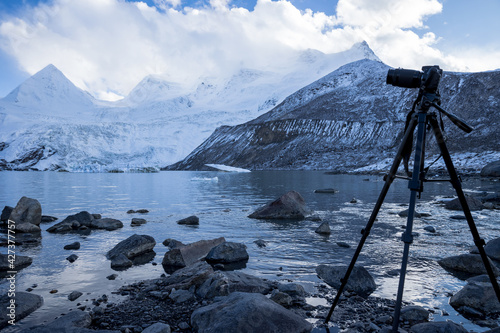 Camera on tripod taking picture of high altitude mountain landscape