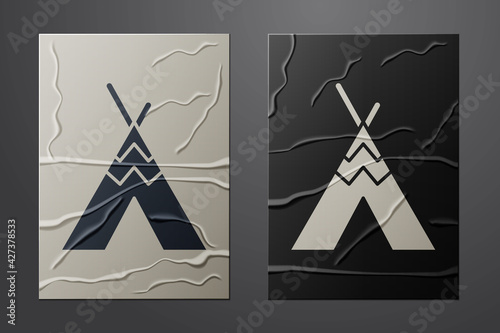 White Traditional indian teepee or wigwam icon isolated on crumpled paper background. Indian tent. Paper art style. Vector