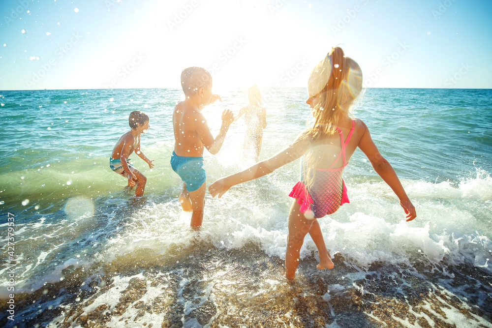 Children have fun on the sandy beach in summer. High quality photo. Children have fun on the sandy beach in summer. High quality photo.