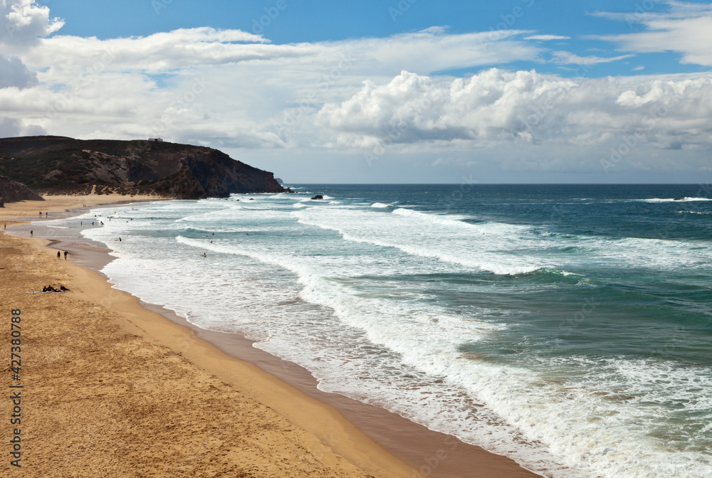 Beautiful seascape with Atlantic Ocean waves on sandy beach Praia do Amado at sunny summer day. Portugal, Algarve, Sagres