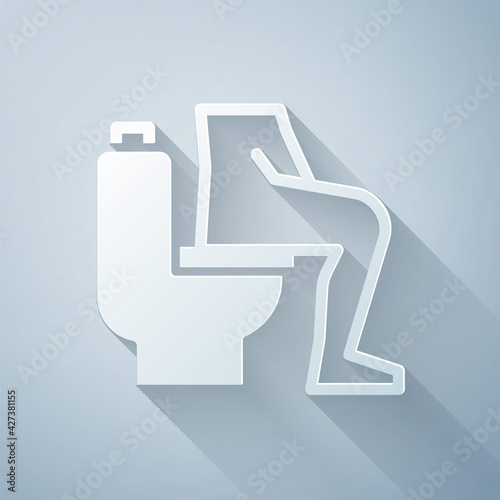Paper cut Men sitting on the toilet and Constipation are experiencing severe abdominal pain icon isolated on grey background. Paper art style. Vector