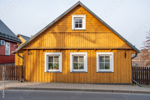 Old Lithuanian traditional yellow wooden house with three windows