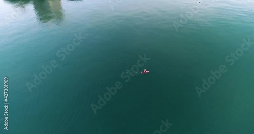 Person paddle boarding in the ocean on a beautiful morning