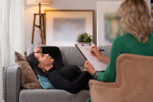 Woman lying in couch during therapy session photo
