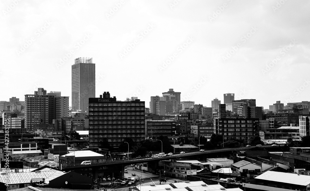 Fototapeta premium JOHANNESBURG, SOUTH AFRICA - Mar 13, 2021: View of Johannesburg Central Business District buildings and lan