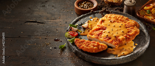 Appetizing dish with breaded meat and sauce