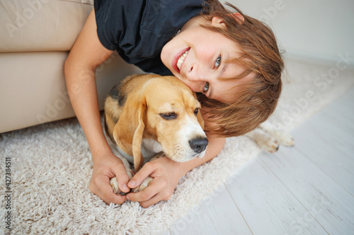 Little boy with a dog at home. Friendship, care, happiness, new concept of the year. High quality photo.