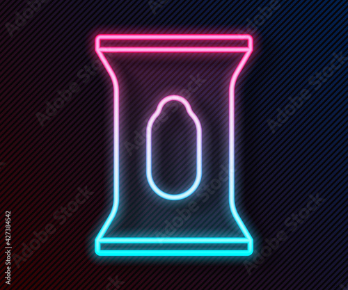 Glowing neon line Wet wipe pack icon isolated on black background. Vector