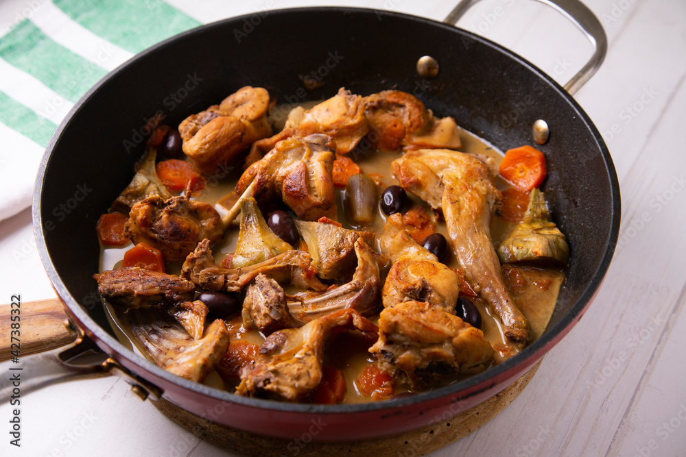 Wild rabbit cocked with artichokes and black olives. Traditional tapa from south spain. Wild rabbit cocked with artichokes and black olives. Traditional tapa from south spain.