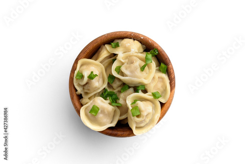 Meat dumplings in wooden bowl with green onion isolated on white background. photo