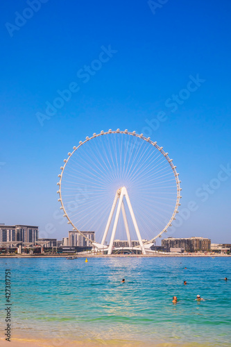 Dubai, UAE - March 04, 2021: Ferris wheel on Dubai Marina beach