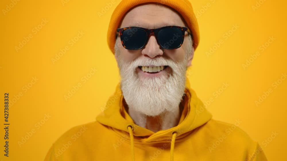 Happy aged man posing in studio. Cheerful mature gentleman smiling indoors. Happy aged man posing in studio. Cheerful mature gentleman smiling indoors.