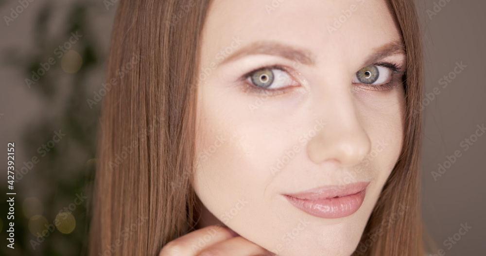 Beauty woman face with green eyes looking at camera. Skin care treatment or cosmetic ads concept. Beautiful female model with perfect fresh and clean skin. Nude make-up. In studio. Beauty woman face with green eyes looking at camera. Skin care treatment or cosmetic ads concept. Beautiful female model with perfect fresh and clean skin. Nude make-up. In studio.