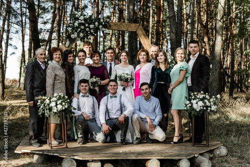 a large family of several generations gathered all together. international group of Family portrait at wedding.parents of a large family. father and mother. Aunt and uncle. brother and sister. husband