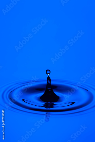 Closeup Image of Blue Water Splash or Falling Rain Drop With Water Ripples.