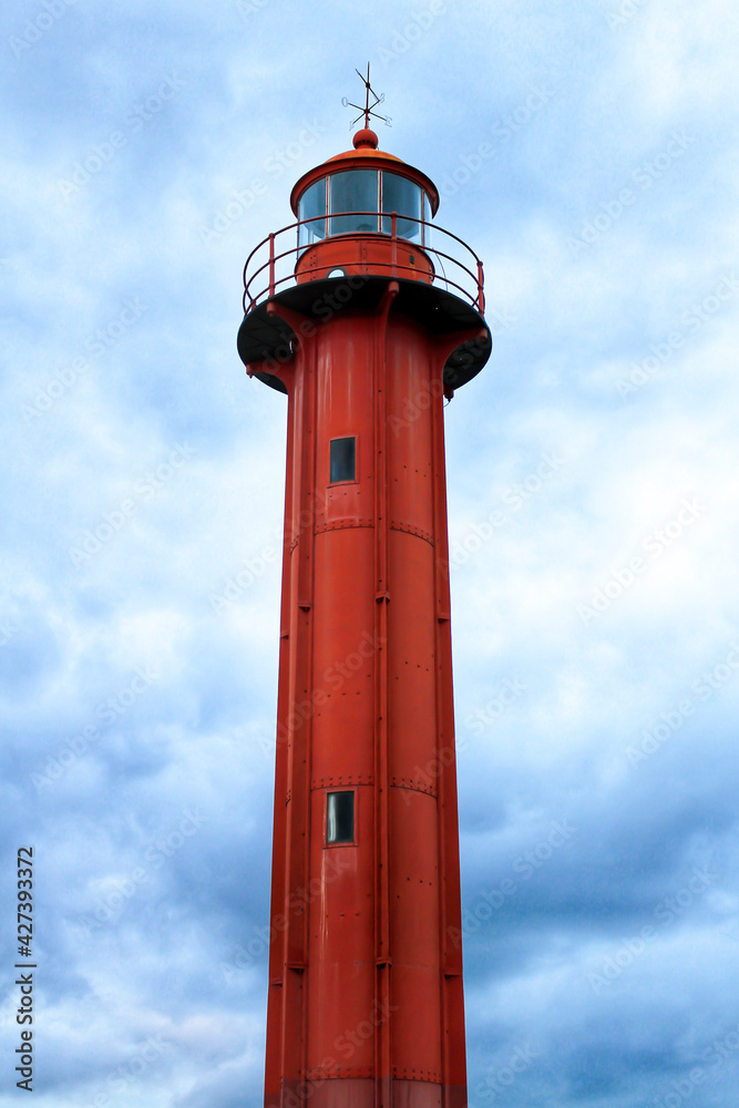 Red lighthouse in the port of Cacilhas village in Lisbon