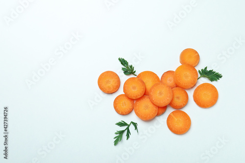 Carrot slices and leaves on white background © Atlas