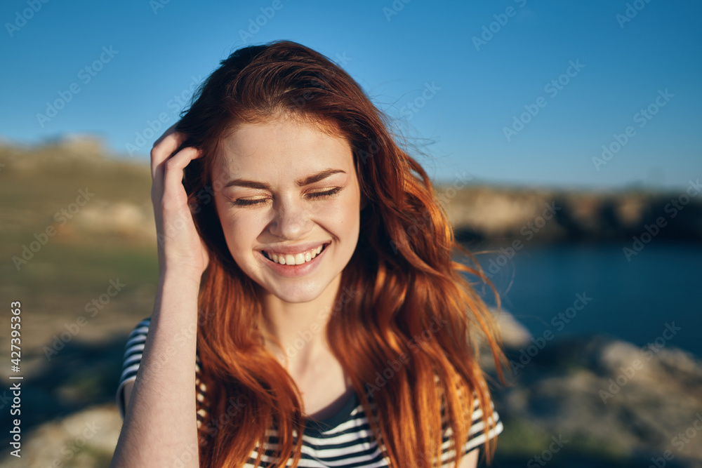 happy woman in the mountains on the beach near the lake vacation relax smile model