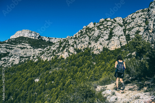 woman hiking on a mountain path in catalonia