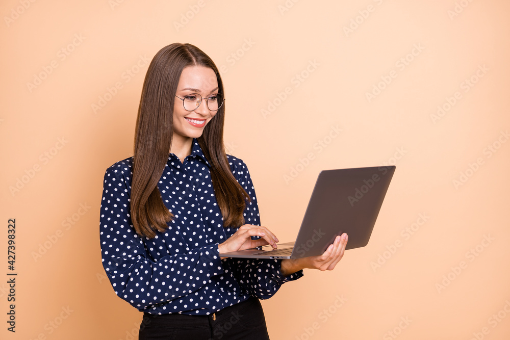 Photo of young business woman happy positive smile look browse laptop programmer isolated over beige color background