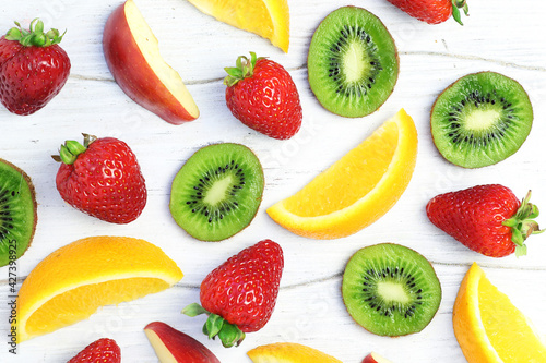 Fruit background with slices of kiwi  strawberry  orange  apple