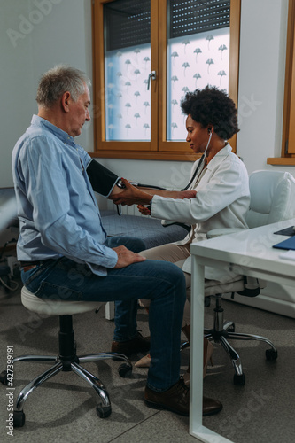 Older person is having blood pressure checked