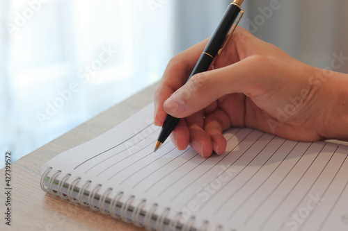 writing on a notebook