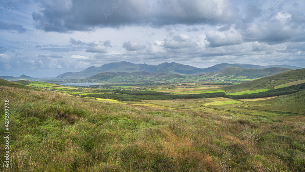 Beautiful valley with green fields, farms, forest and lake, surrounded by hills and mountains, Dingle Peninsula, Wild Atlantic Way, Kerry, Ireland