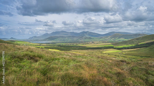 Beautiful valley with green fields, farms, forest and lake, surrounded by hills and mountains, Dingle Peninsula, Wild Atlantic Way, Kerry, Ireland